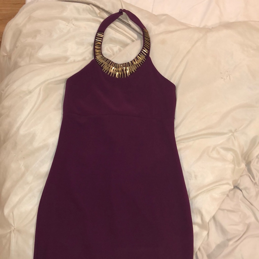 Purple dress, with a gold around the collar.
